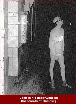 John Lennon stands on a Hamburg street in his underwear. John ventured out into the night on a dare from his mates.
